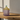 Opbevaringskrukke med striber - violet og gul fra EJA – med grøn plante som indretning